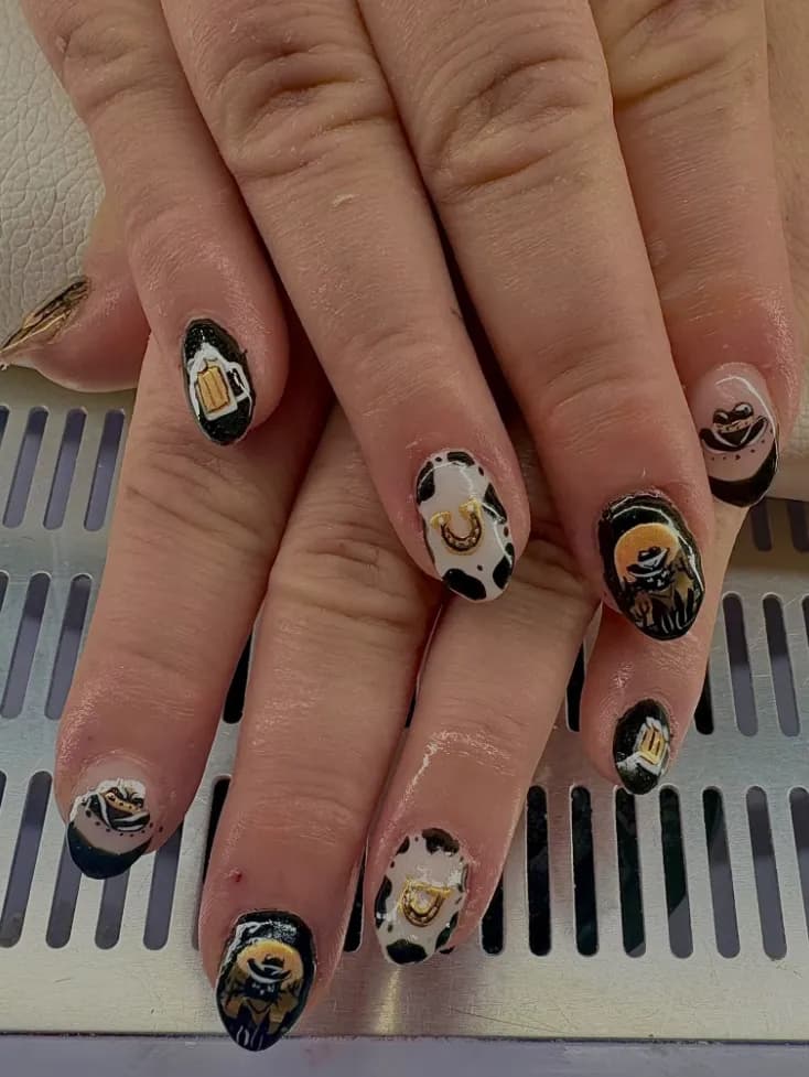 Western nail art with cowboys, horseshoes and cow print
