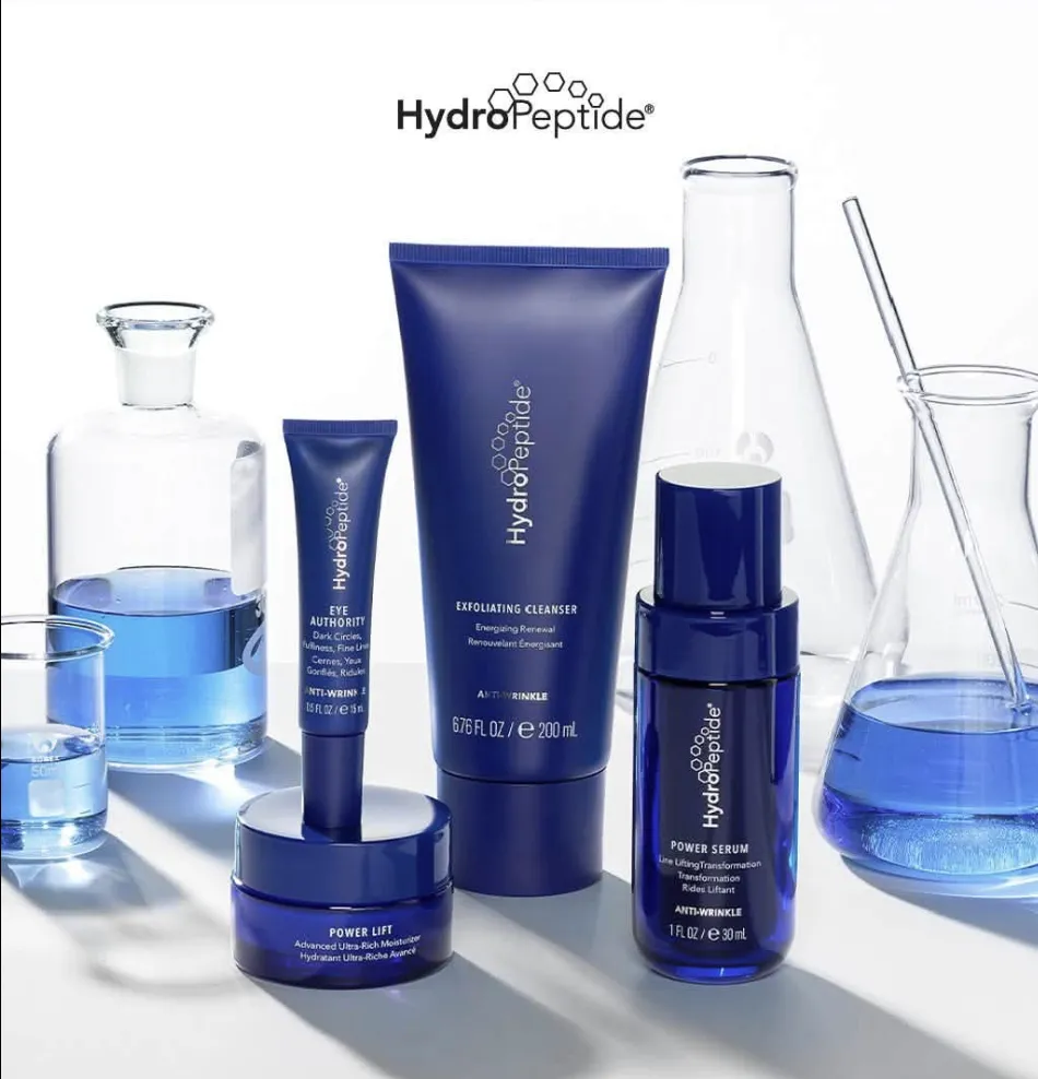 Navy HydroPeptide anti-wrinkle products among glass lab flasks