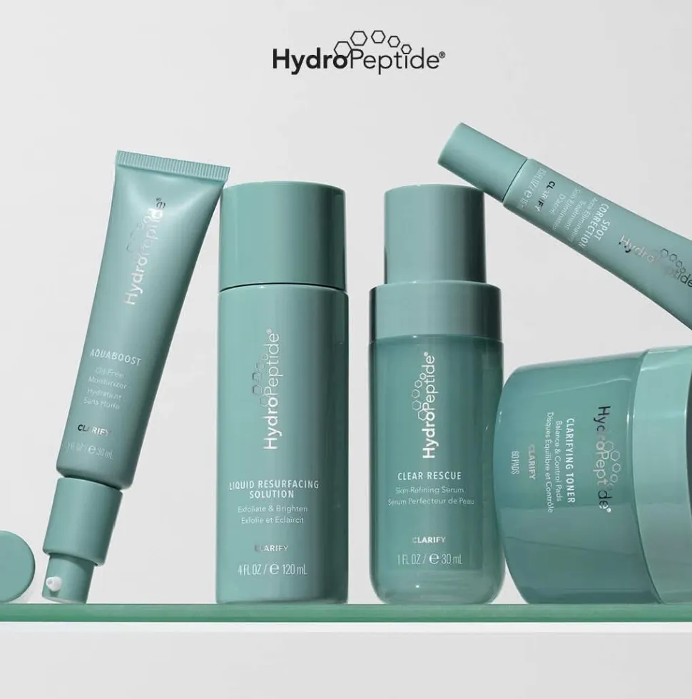 Teal HydroPeptide Clarify products lined up on a shelf