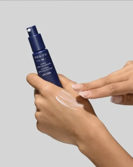 A navy pump bottle of HydroPeptide Face Lift, with a little smoothed on the back of the hand