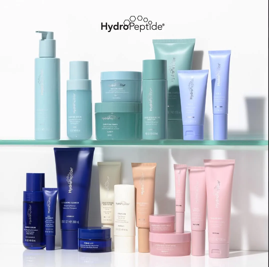 HydroPeptide skincare bottles, jars and tubes on two glass shelves