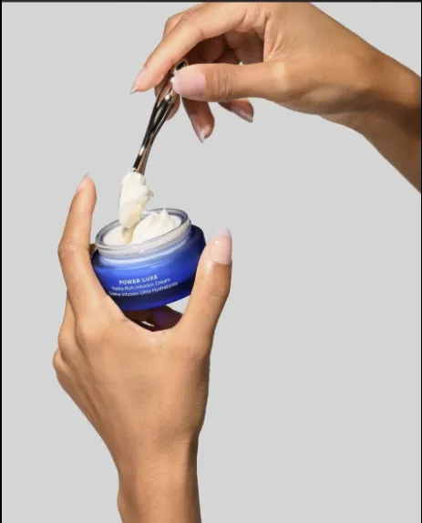 A spatula scooping HydroPeptide Power Luxe cream from its jar